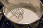 White sauce being whisked constantly